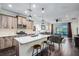 Open concept kitchen with a large island, modern appliances, and barstool seating at 3520 Woodmont Dr, Parrish, FL 34219