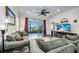 Cozy living room featuring plush sofas, a ceiling fan, and a beautiful water view at 3520 Woodmont Dr, Parrish, FL 34219