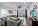 Relaxing living room featuring a large sofa, water views, and dark hardwood floors at 3520 Woodmont Dr, Parrish, FL 34219