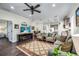 Open living space featuring comfortable sofas, dark floors and a flat-screen TV at 3520 Woodmont Dr, Parrish, FL 34219