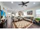Spacious living room with elegant furnishings, hardwood floors, and seamless flow into an open kitchen area at 3520 Woodmont Dr, Parrish, FL 34219