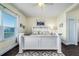Bright bedroom featuring a large window, light walls, a ceiling fan, and a comfortable bed at 3520 Woodmont Dr, Parrish, FL 34219