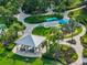 Community park featuring a covered picnic area, playground, and lush tropical landscaping at 3520 Woodmont Dr, Parrish, FL 34219