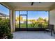 Enclosed patio showcasing outdoor seating and a serene view of the community lake at 3520 Woodmont Dr, Parrish, FL 34219