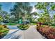A green playground with a slide and climbing bars set in an area surrounded by mature landscaping at 3520 Woodmont Dr, Parrish, FL 34219