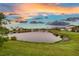 Beautiful pond view with colorful sky in a well-maintained community at 3520 Woodmont Dr, Parrish, FL 34219