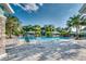 Community pool featuring lounge chairs, palm trees, shaded areas, and a refreshing pool for relaxation at 3520 Woodmont Dr, Parrish, FL 34219
