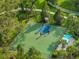 The basketball court is surrounded by mature trees, playground, and is great for people of all ages at 3520 Woodmont Dr, Parrish, FL 34219