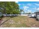 This spacious backyard features green grass, a fence, a sitting area, and palm trees at 3828 20Th N St, St Petersburg, FL 33714