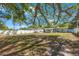 This spacious backyard features green grass, a fence, and trees at 3828 20Th N St, St Petersburg, FL 33714