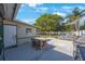 This backyard features string lights, a dining table, a sitting area, a fence, and a grill at 3828 20Th N St, St Petersburg, FL 33714