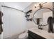 This bathroom features a shower with a curtain, shelving, a toilet, and a sink with a round mirror at 3828 20Th N St, St Petersburg, FL 33714