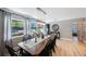 Dining room featuring a wood table, black chairs, and three large picture windows at 3828 20Th N St, St Petersburg, FL 33714