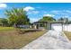 Landscaped front yard of a single-story home with a covered entryway and driveway at 3828 20Th N St, St Petersburg, FL 33714
