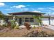Inviting exterior with lush landscaping, covered entrance, and attached one-car garage at 3828 20Th N St, St Petersburg, FL 33714