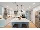 Modern kitchen featuring white cabinets, subway tile backsplash, stainless steel appliances, and a center island at 3828 20Th N St, St Petersburg, FL 33714