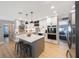 Stylish kitchen featuring white cabinetry, stainless appliances, tile backsplash, and a center island with seating at 3828 20Th N St, St Petersburg, FL 33714