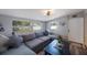 Cozy living room featuring a comfortable sectional sofa, wood flooring, and plenty of natural light at 3828 20Th N St, St Petersburg, FL 33714