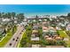 Scenic aerial shot shows homes near a bustling beach with blue waters and clear skies at 4001 5Th Ave, Holmes Beach, FL 34217