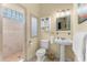 Cozy bathroom with a walk-in shower, pedestal sink, and neutral tones at 4001 5Th Ave, Holmes Beach, FL 34217