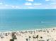 Bustling beach scene with white sand, clear turquoise water, and beachgoers enjoying a sunny day at 4001 5Th Ave, Holmes Beach, FL 34217