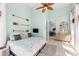Cozy bedroom featuring nautical decor, a ceiling fan, and an open doorway leading to another room at 4001 5Th Ave, Holmes Beach, FL 34217