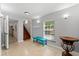 Bright foyer features tile floors, staircase, and a bench by the window at 4001 5Th Ave, Holmes Beach, FL 34217