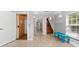 Bright foyer features tile floors, staircase, elevator, and a bench by the window at 4001 5Th Ave, Holmes Beach, FL 34217