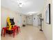Large game room area with tile floors, Pac-Personal arcade, and sliding glass door to the exterior at 4001 5Th Ave, Holmes Beach, FL 34217
