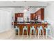 Bright kitchen boasts dark wood cabinets, a long breakfast bar with seating, and stainless steel appliances at 4001 5Th Ave, Holmes Beach, FL 34217
