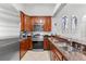 This kitchen features stainless steel appliances, granite countertops, and dark wood cabinets at 4001 5Th Ave, Holmes Beach, FL 34217