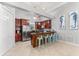 Well-appointed kitchen with island seating, stainless appliances, wood cabinetry, and tiled flooring for easy maintenance at 4001 5Th Ave, Holmes Beach, FL 34217