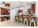 Bright kitchen boasts dark wood cabinets, a long breakfast bar with seating, and stainless steel appliances at 4001 5Th Ave, Holmes Beach, FL 34217