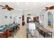 Open-concept living and dining areas with high ceilings, ceiling fans, and access to the kitchen at 4001 5Th Ave, Holmes Beach, FL 34217