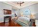 This main bedroom features a beverage bar, hardwood floors and tray ceilings with a fan at 4001 5Th Ave, Holmes Beach, FL 34217