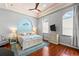 Inviting main bedroom features hardwood floors, a decorative tray ceiling, and coastal-themed decor at 4001 5Th Ave, Holmes Beach, FL 34217