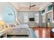 Serene main bedroom with hardwood floors, a tray ceiling, and soothing coastal decor at 4001 5Th Ave, Holmes Beach, FL 34217