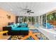 Covered patio with comfortable seating, colorful decor, and access to the lush outdoor pool area at 4001 5Th Ave, Holmes Beach, FL 34217