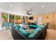Comfortable enclosed patio featuring a large seating area, decor, and open access to the outdoors at 4001 5Th Ave, Holmes Beach, FL 34217