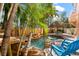 This custom pool area features a grotto with waterfall, tropical landscaping and a tiki hut at 4001 5Th Ave, Holmes Beach, FL 34217