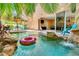 Tropical backyard oasis with private pool, rock waterfall, outdoor dining, and seamless indoor-outdoor living at 4001 5Th Ave, Holmes Beach, FL 34217