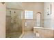 Inside the main bath you'll find a tiled shower with multiple shower heads and built-in shelves at 4001 5Th Ave, Holmes Beach, FL 34217