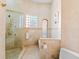 The main bath has a tiled walk-in shower with glass door, and multiple shower heads at 4001 5Th Ave, Holmes Beach, FL 34217
