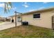 Backyard featuring an AC unit, some sparse grass, and a sliding glass door at 4221 3Rd W Ave, Palmetto, FL 34221