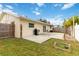 Backyard patio with a fence, grass, and grill outside of home at 4221 3Rd W Ave, Palmetto, FL 34221