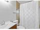 Bathroom featuring a vanity, toilet, and shower with a white curtain and tile accent at 4221 3Rd W Ave, Palmetto, FL 34221