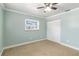 Neutral bedroom with a ceiling fan and closet and large window at 4221 3Rd W Ave, Palmetto, FL 34221