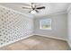 Bedroom featuring accent wall, ceiling fan, carpet, and a window with blinds at 4221 3Rd W Ave, Palmetto, FL 34221