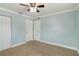 Neutral bedroom featuring a ceiling fan, closet and two doorways at 4221 3Rd W Ave, Palmetto, FL 34221
