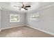 Neutral bedroom with carpet, ceiling fan, and two windows providing natural light at 4221 3Rd W Ave, Palmetto, FL 34221